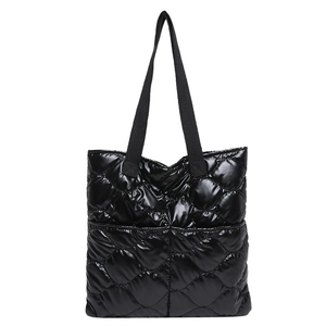 Chic black quilted tote bag with glossy finish and top handles for modern women