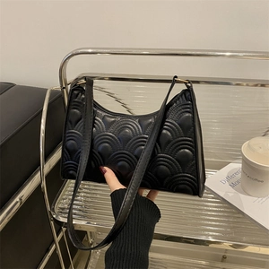 French style black underarm bag with quilted shell pattern and slim shoulder strap