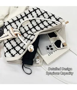 Top view of tweed plaid tote bag showing spacious interior with phone and sunglasses