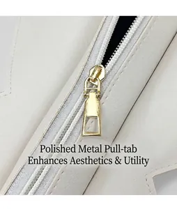 Macro view of gold-tone metal zipper on minimalist cream leather shoulder tote bag