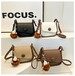 Mini crossbody bags in black, white, and brown with cute plush monster charms