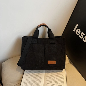 Large capacity black corduroy tote bag with dual front pockets and wide shoulder strap