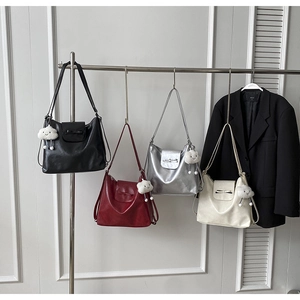 Detail of multi-color vintage bows shoulder bags with cute cloud charms on display