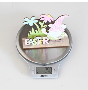 Detailed close-up of a wooden Easter gnome ornament weighing 27.0g on a digital scale