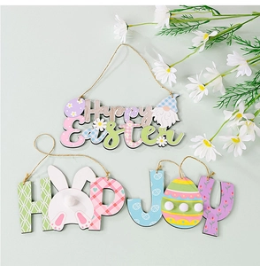 Close-up of wooden Easter ornaments featuring Happy Easter, HOP and JOY letter designs