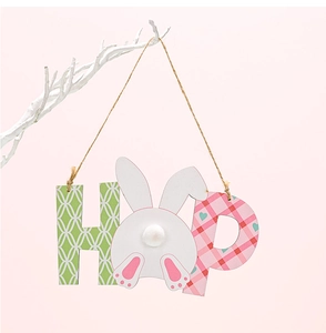 Close-up of wooden Easter HOP hanging ornament with bunny tail design on white branch