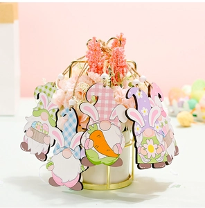 Detail of Easter wooden gnome ornaments with rabbit ears and beads on decorative branch