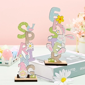 Close-up of wooden Easter ornaments featuring Spring and Easter text with bunnies