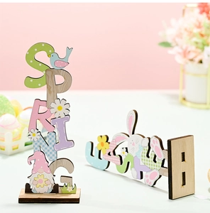 Close-up of Easter wood gnome decoration and SPRING vertical letter sign on white table