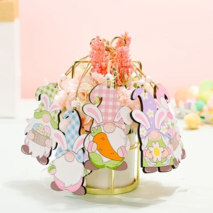 Easter wooden gnome ornaments set with colorful rabbit ears and carrots hanging on flowers