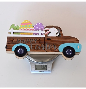 Detailed view of Happy Easter wooden truck sign on a digital scale weighing 166.9g