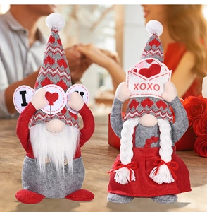 Detail of plush Valentine Gnomes set with red heart patterns on a rustic wooden table