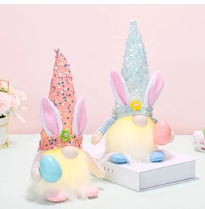Detail von Oster-Gnom-Puppen mit Paillettenhut und LED-Licht im rosa Hintergrund