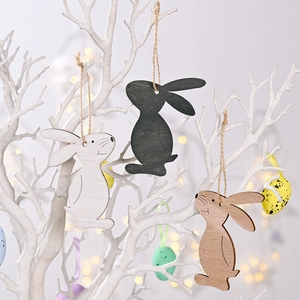 Minimalist wooden Easter bunny ornaments in white and natural wood on a white branch
