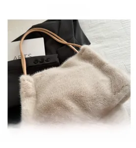 Detail view of large cream faux fur tote bag with slim faux leather shoulder straps