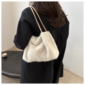 Detailed texture of off-white faux fur tote bag showing plush fibers and leather straps