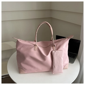 Pink waterproof nylon tote bag set showing the reinforced leather handles and small pouch