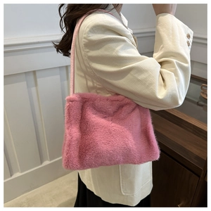 Detail showing plush pink faux fur texture and slim shoulder strap of the tote bag