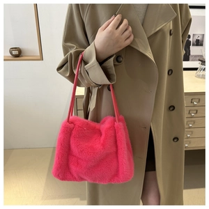 Detailed view of vibrant pink faux fur tote bag styled with a beige trench coat