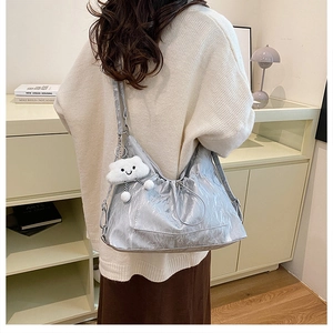 Silver pleated shoulder bag featuring a metallic finish and cute cloud charm accessory