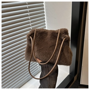 Close-up of brown faux fur shoulder bag with soft plush texture and slim leather straps