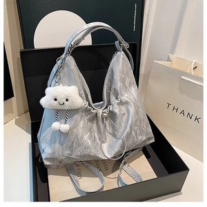 Silver pleated faux leather tote bag in a black gift box with a white cloud charm