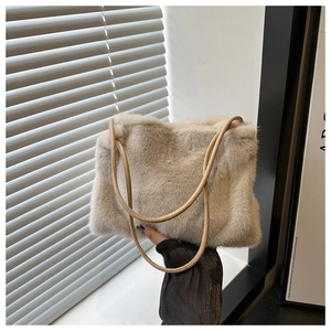 Detailed view of beige faux fur tote bag featuring durable brown leather rope handles