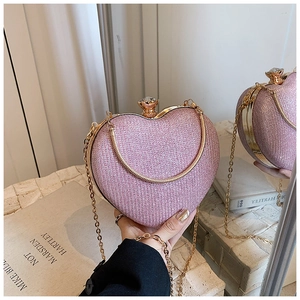 Detail of pink glitter heart bag with gold frame and sparkling rhinestone buckle