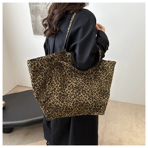 Fashionable leopard print tote bag shown being worn over the shoulder in a stylish room