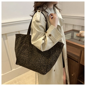 Close-up of leopard print canvas tote bag with front pocket detail for woman's style