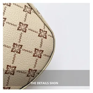 Close-up of beige lychee grain leather with vintage brown floral monogram pattern