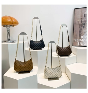 Detailed display of four retro hobo bags in black, brown, and white with geometric prints