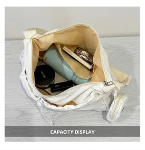 Detailed top view of off-white crossbody tote showing large capacity for daily essentials