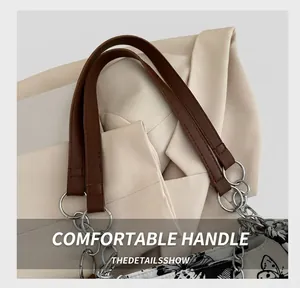 Detail of brown leather strap with silver metal chain and butterfly print pattern