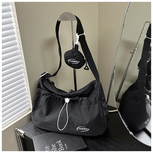 Detail of black nylon pleated tote bag with fashion logo and mini coin purse set