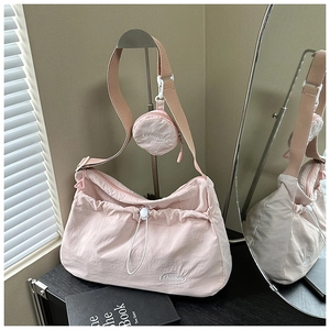 Pink drawstring canvas tote bag detail with matching round coin purse and Fashion logo