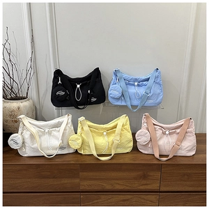 Detail of colorful nylon crescent crossbody bags showing drawstring and round coin pouches