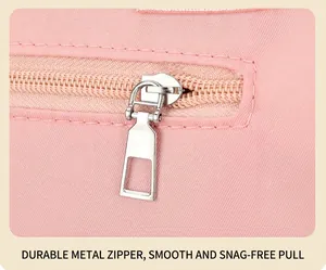 Close-up of durable silver metal zipper and smooth slider on pink nylon tote bag