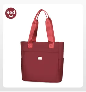Detailed front view of a red nylon tote bag featuring durable handles and side pockets