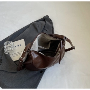 Close-up of tote bag interior featuring spacious main compartment and herringbone lining