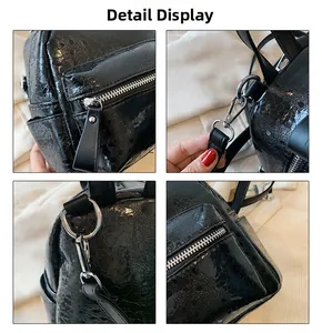 Close-up of black glossy cracked leather backpack with silver zippers and metal hooks