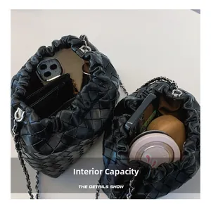 Internal capacity of the black woven bucket bag showing phone and wallet storage