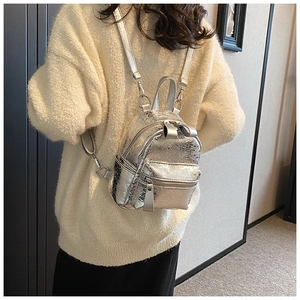 Silver metallic mini backpack with cracked leather texture shown on model back