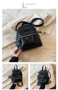 Detail of a black patent leather mini backpack with crackle texture and zipper front pocket