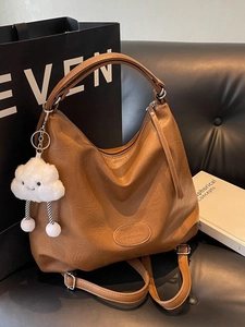 Brown large capacity leather tote bag with cloud charm and adjustable shoulder strap