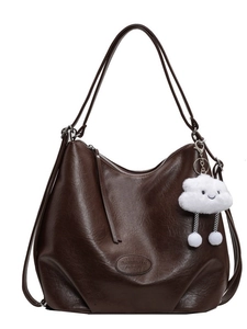 Brown large capacity leather tote bag with shoulder straps and white plush charm