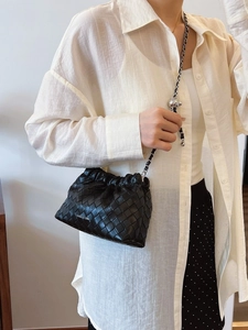 Women's black woven leather bucket bag with silver chain strap and sphere metal buckle