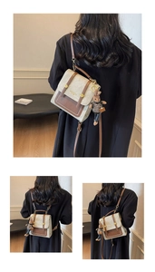 Detail of vintage canvas mini backpack with brown leather trim and a rabbit charm