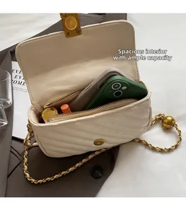Detail view of the open beige chevron quilted bag showing spacious interior compartment