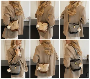 Detail view of vintage bucket bags in brown and black with Santa Claus plush charms